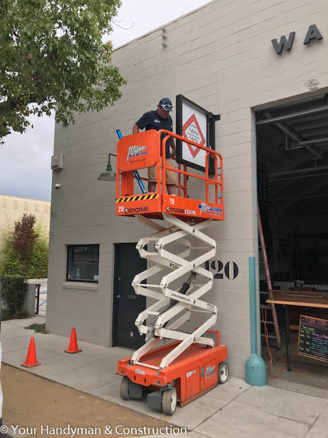 commercial sign installation with scissor lift